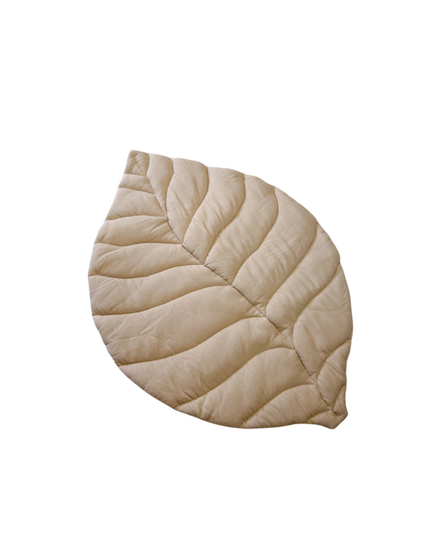 Pale pink linen leaf-shaped play mat on nursery floor