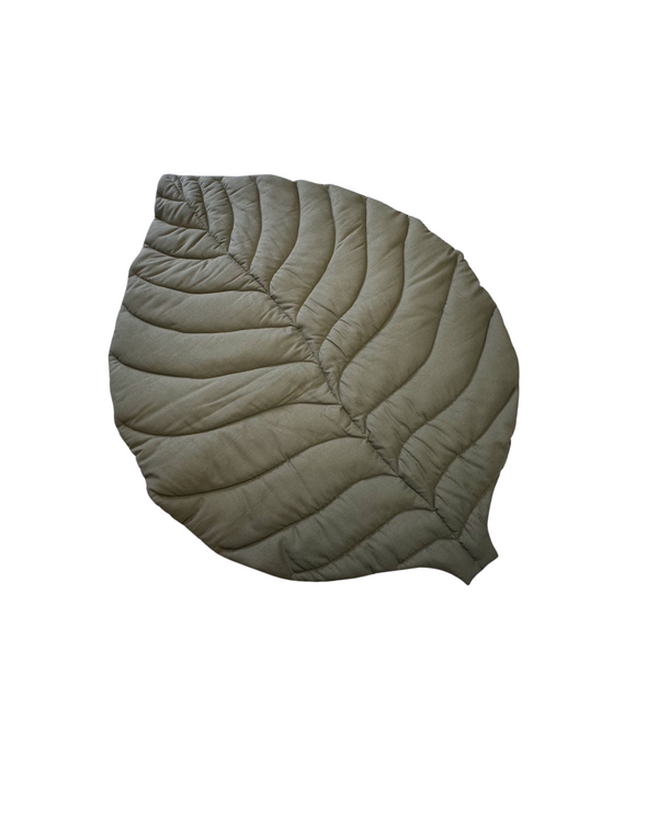 Khaki linen leaf baby play mat on wooden nursery floor with natural toys