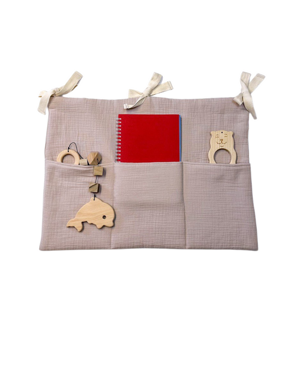 Beige and light pink cotton muslin toy pocket with three compartments for nursery storage