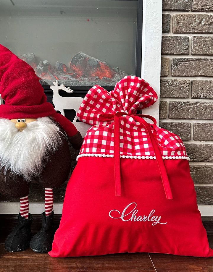 Close-up of embroidered name on green Santa sack