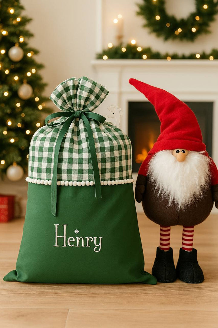 Green Santa gift sack under Christmas tree with presents