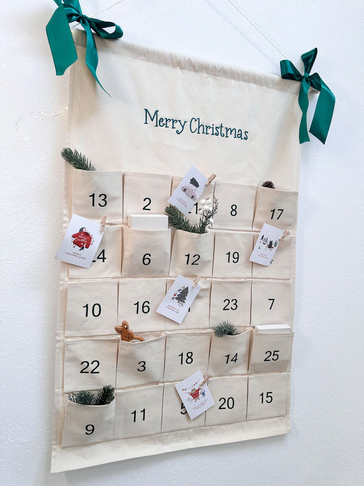 A fabric Advent calendar with pockets numbered 1 to 25