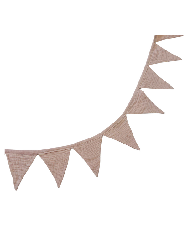 Pale pink muslin bunting garland hanging across a nursery wall with triangle flags