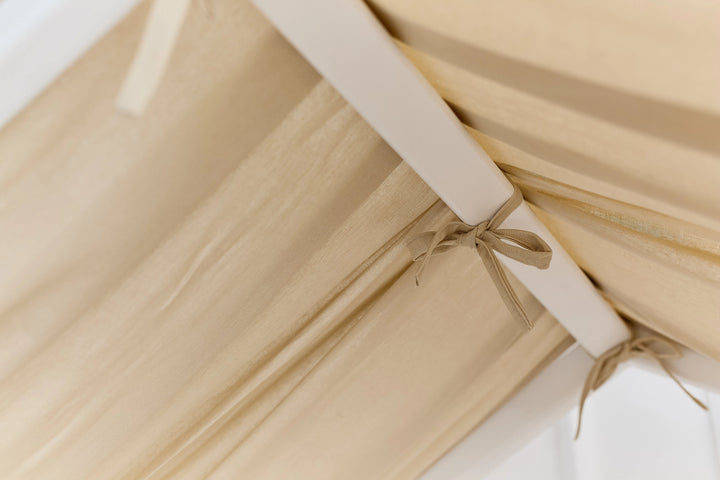 Organic linen canopy draped over toddler house bed Beige Linen Baby Canopy Curtains – Natural Comfort for Montessori and House Beds hellolittlefox linen-baby-beige-canopy-new-bed-curtains-perfect-for-montessori hellolittlefox.myshopify.com