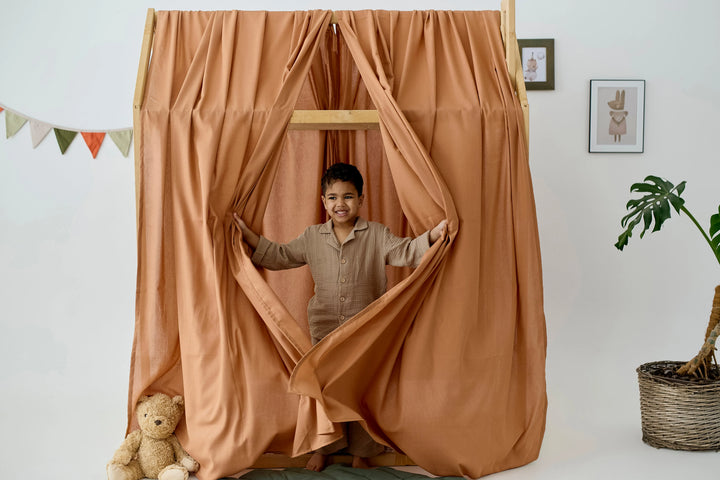 Twin size bed with soft terracotta linen canopy curtains