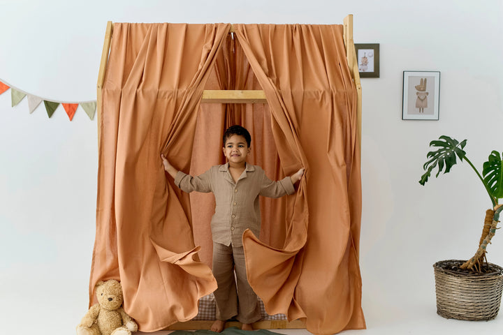 Organic linen canopy in terracotta shade for toddler bed