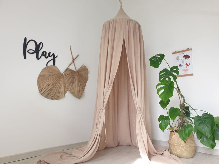 An airy Beige muslin canopy providing a soothing and cozy retreat in a bedroom