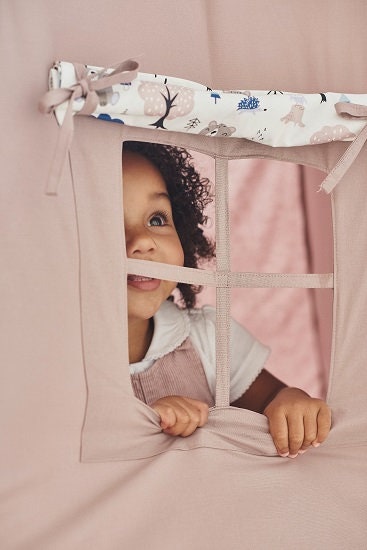 Indoor playhouse with dusty brown woodland print teepee for kids, perfect for playtime