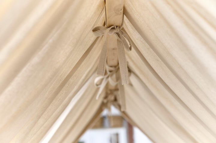 Soft linen toddler bed curtains tied neatly on each side of a house bed Beige Linen Canopy Curtains for Montessori House Bed | Organic Toddler Bed Canopy for Kids Room Decor hellolittlefox canopy-bed-curtains-aesthetic-room-decor-linen-bed-curtains-nursery-linen-bed-curtains-montessori-house-bed-canopy-toddler-bedding hellolittlefox.myshopify.com