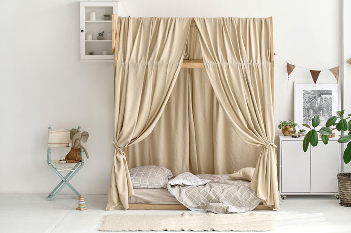 Natural linen bed canopy draped over a wooden house bed frame Beige Linen Canopy Curtains for Montessori House Bed | Organic Toddler Bed Canopy for Kids Room Decor hellolittlefox canopy-bed-curtains-aesthetic-room-decor-linen-bed-curtains-nursery-linen-bed-curtains-montessori-house-bed-canopy-toddler-bedding hellolittlefox.myshopify.com