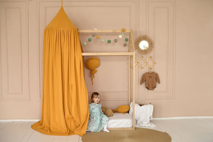 Cotton canopy in mustard color above wooden bed Mustard Muslin House Bed Canopy | Boho Canopy for Girls’ Room, Playhouse, Reading Nook hellolittlefox canopy-for-house-bed-for-girls-nursery-canopy-cotton-crib-cover-cozy-nursery-canopy-baldachin-baby-crib-cover-cotton-canopy hellolittlefox.myshopify.com